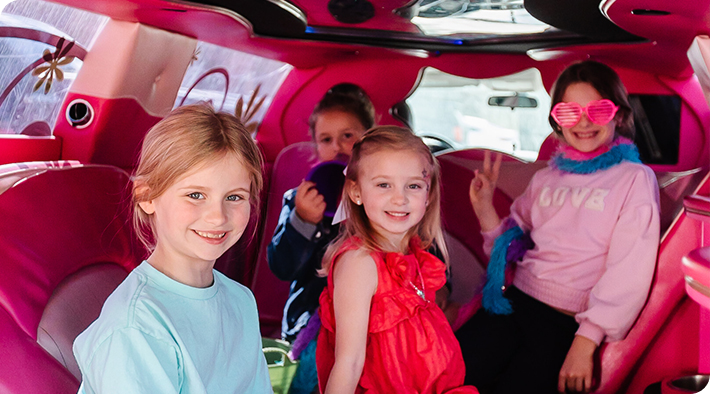 Girls smiling in a limo.