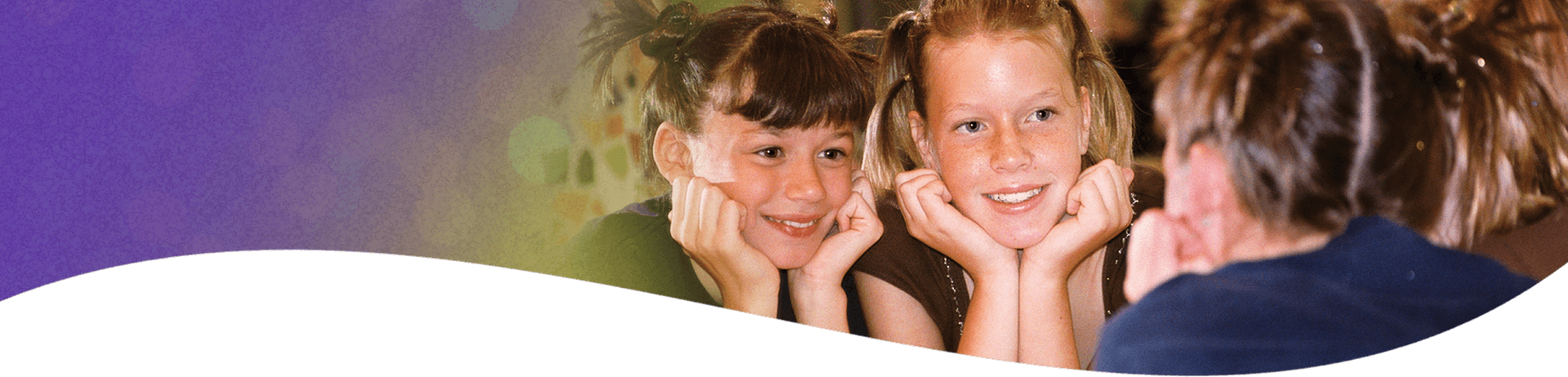 2 girls looking in a mirror