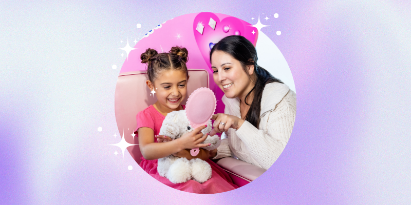 young girl looking in a mirror at her earrings
